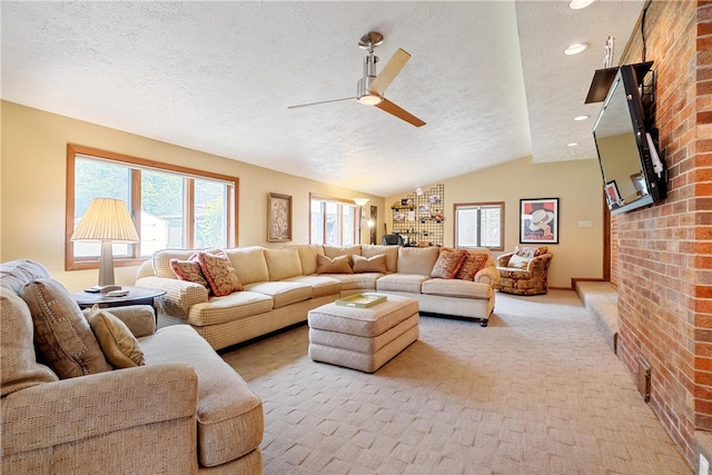 carpeted living room featuring lofted ceiling, ceiling fan, and a textured ceiling