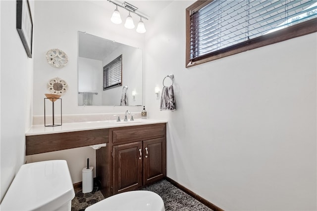 bathroom featuring vanity and toilet