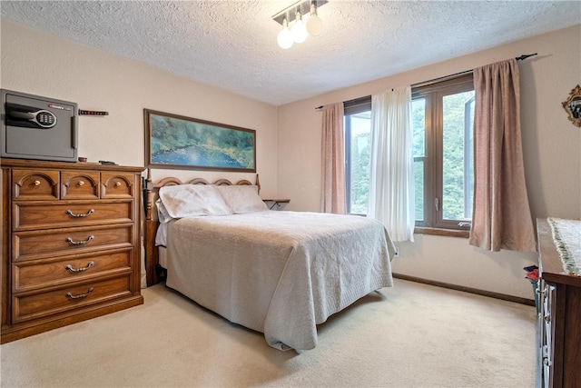 carpeted bedroom featuring a textured ceiling