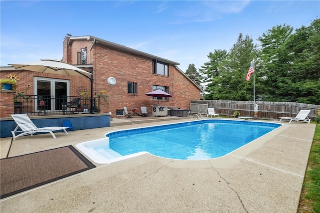 view of pool with a diving board and a patio