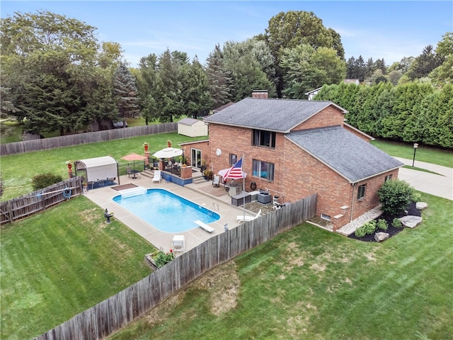 view of pool with a yard, a patio area, and central AC