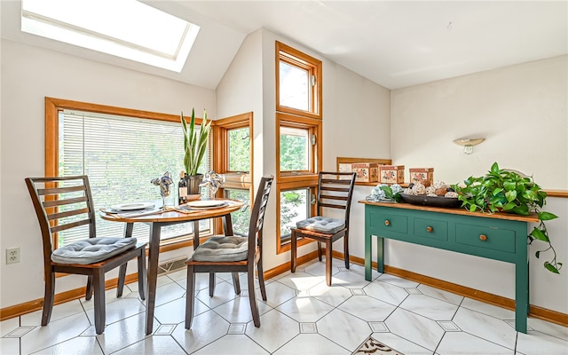 dining room with lofted ceiling with skylight