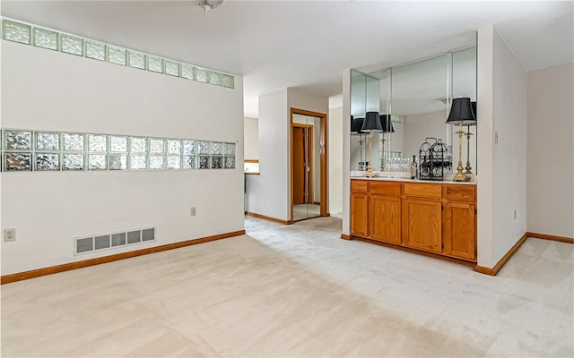 kitchen featuring light carpet