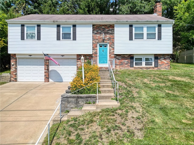 bi-level home featuring a garage and a front yard