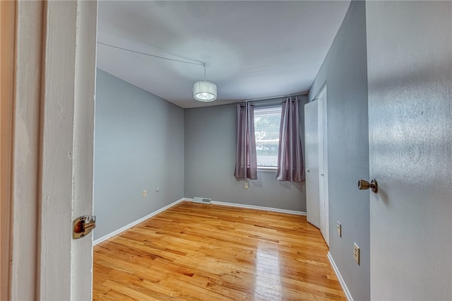 empty room with light hardwood / wood-style floors