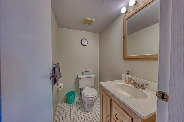 bathroom with vanity, toilet, and tile patterned floors