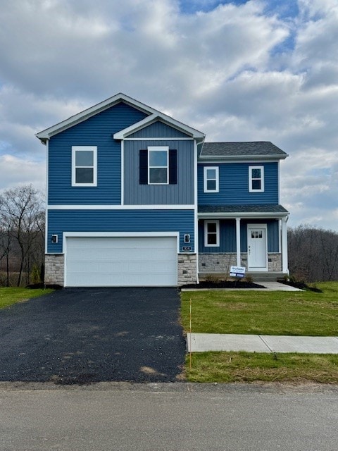 view of front of home with a garage and a front lawn