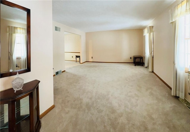 carpeted empty room featuring a healthy amount of sunlight