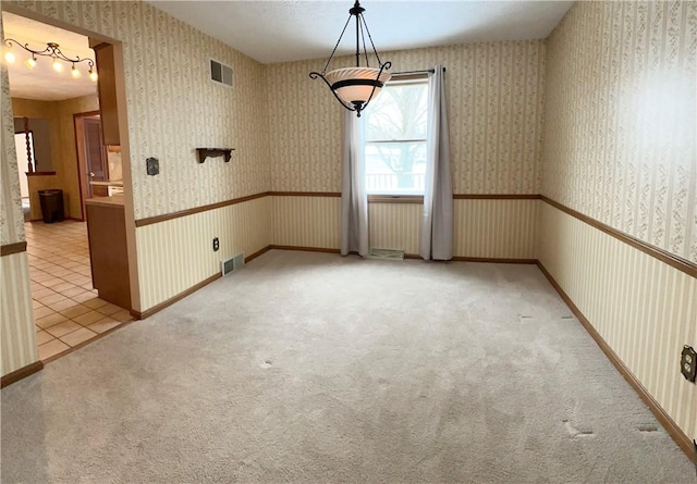 unfurnished room featuring light carpet