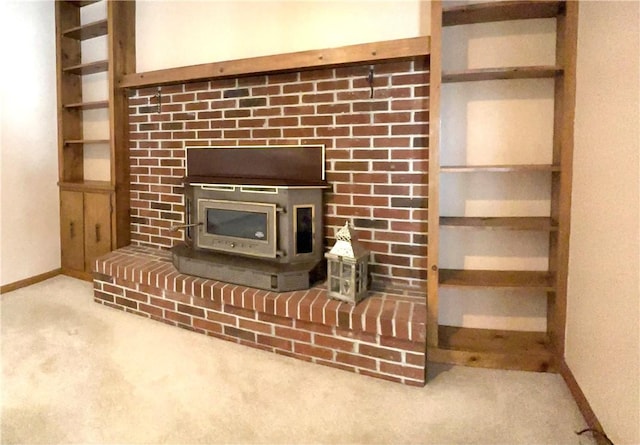 details featuring carpet flooring, a wood stove, and built in features