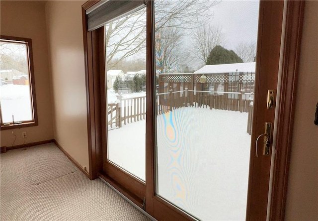 doorway to outside featuring light carpet