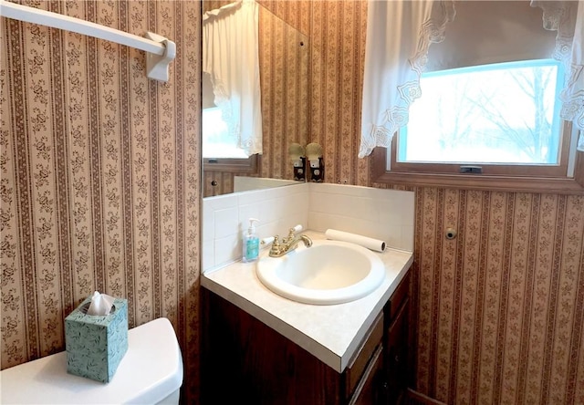 bathroom featuring vanity and toilet