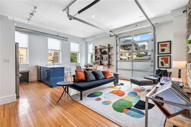 living room with sink and light hardwood / wood-style flooring