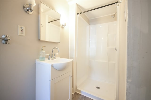 bathroom with walk in shower and vanity