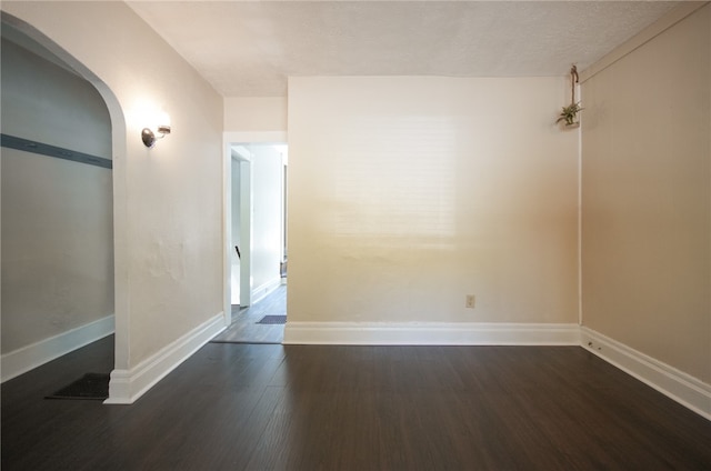 spare room with dark hardwood / wood-style floors