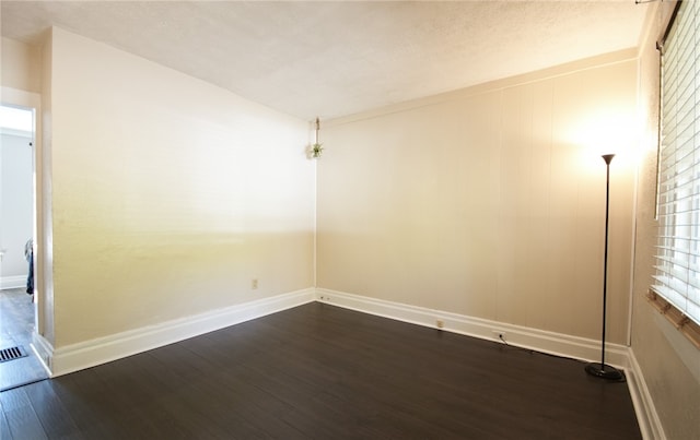 unfurnished room with dark hardwood / wood-style floors