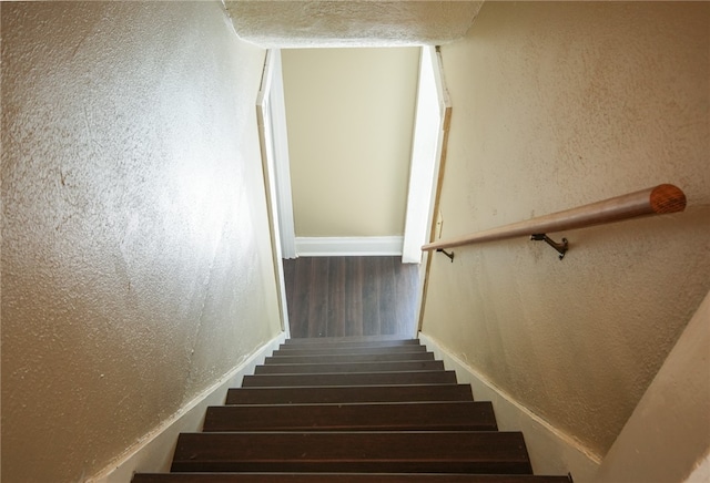 staircase with hardwood / wood-style flooring