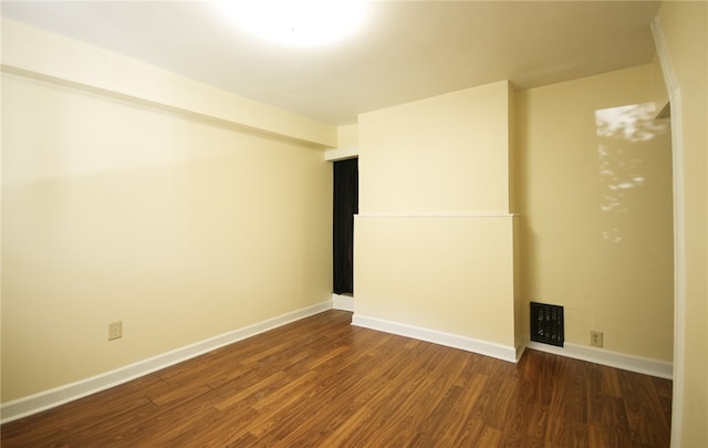 spare room with dark hardwood / wood-style flooring