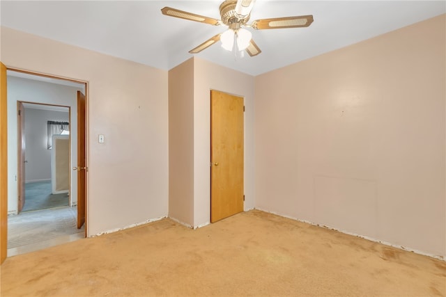 carpeted empty room with ceiling fan