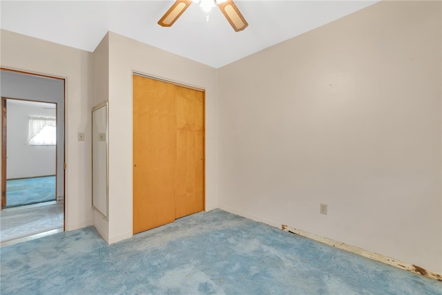 unfurnished bedroom featuring carpet, ceiling fan, and a closet