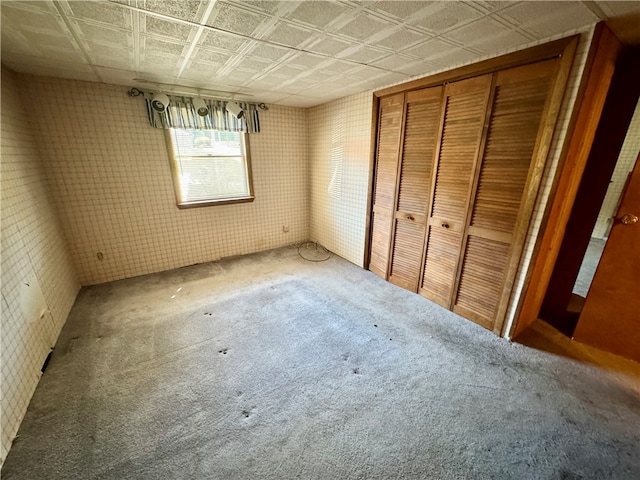 unfurnished bedroom featuring a closet and carpet