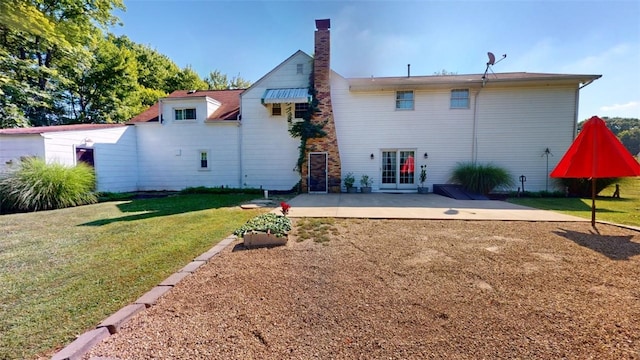 back of property with french doors, a yard, and a patio