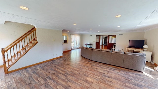 unfurnished living room with crown molding and hardwood / wood-style flooring