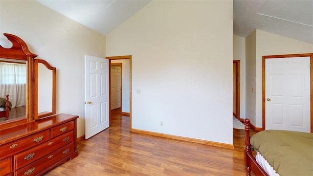 bedroom featuring lofted ceiling and light hardwood / wood-style floors