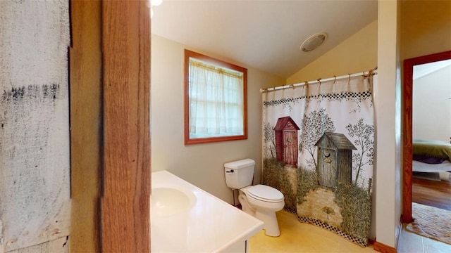 bathroom featuring curtained shower, tile patterned flooring, vaulted ceiling, toilet, and vanity