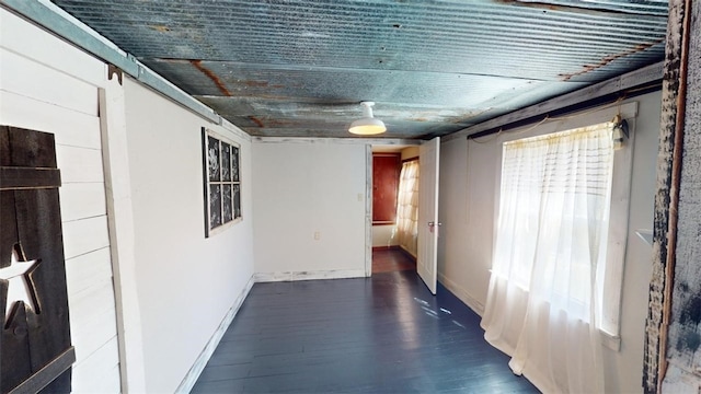 hallway featuring plenty of natural light, dark hardwood / wood-style floors, and a barn door