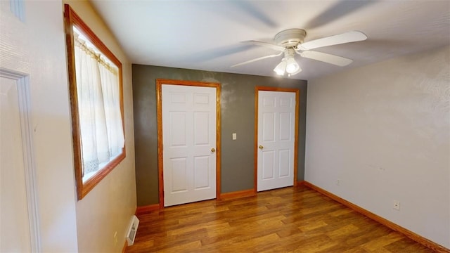 unfurnished bedroom featuring hardwood / wood-style floors and ceiling fan