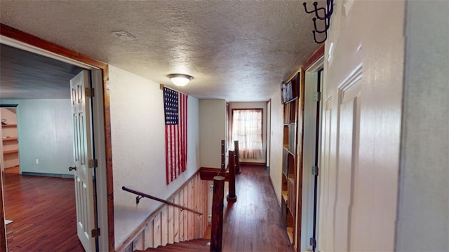 hallway with dark hardwood / wood-style flooring and a textured ceiling