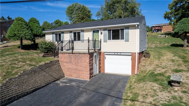 view of front of property with a front yard and a garage