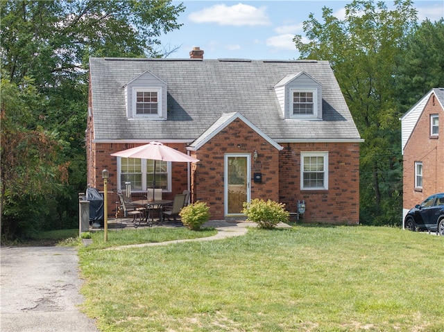 new england style home with a front yard