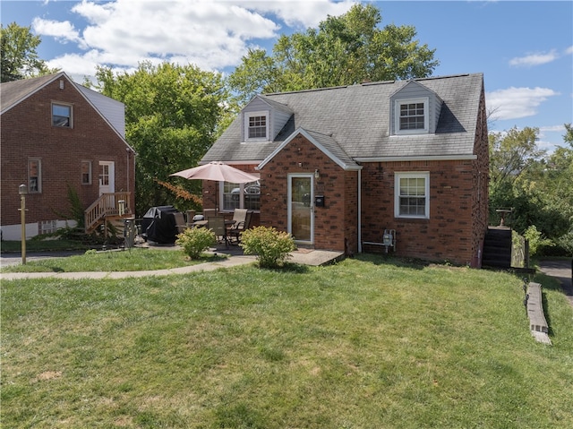 new england style home featuring a patio and a front lawn