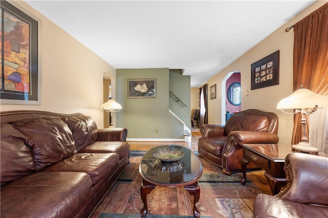 living room featuring dark hardwood / wood-style flooring and a textured ceiling