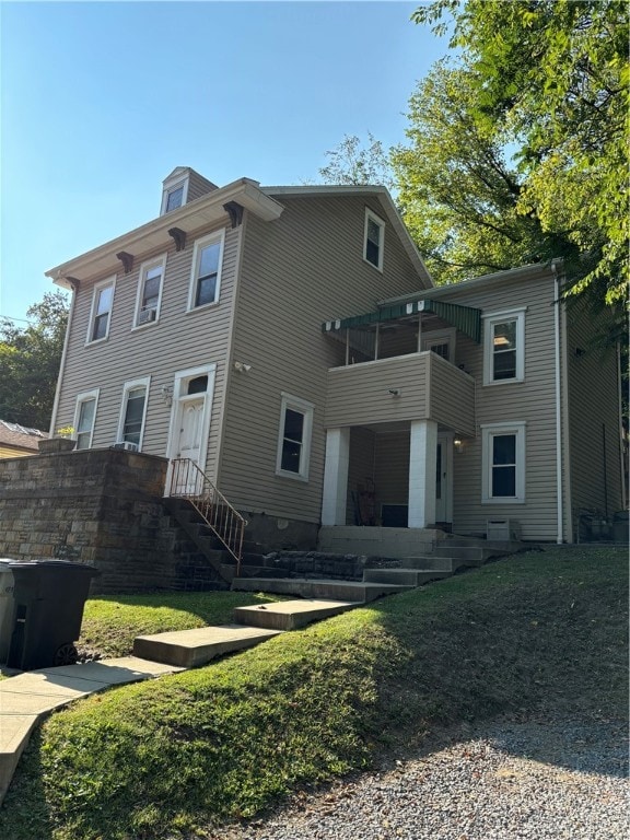 rear view of property with a balcony