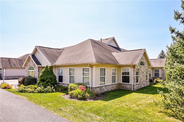 view of side of home with a yard