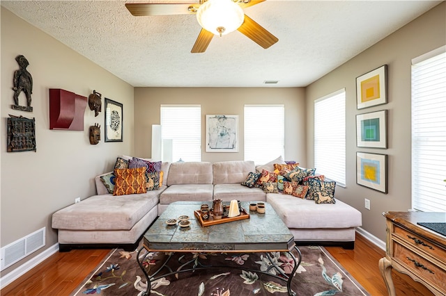 living room featuring a wealth of natural light, ceiling fan, and hardwood / wood-style floors