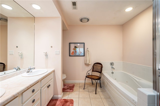 bathroom featuring vanity, tiled tub, tile patterned floors, and toilet