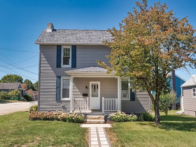 view of front of house with a front yard and a porch