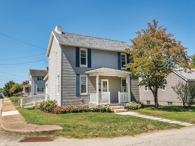 view of front of property featuring a porch and a front lawn