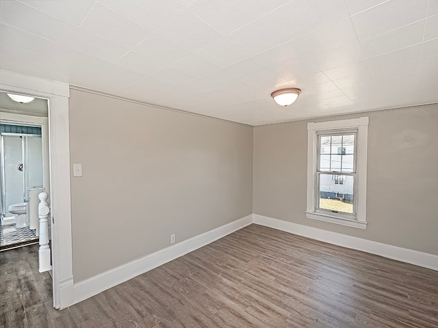 unfurnished room featuring dark wood-type flooring