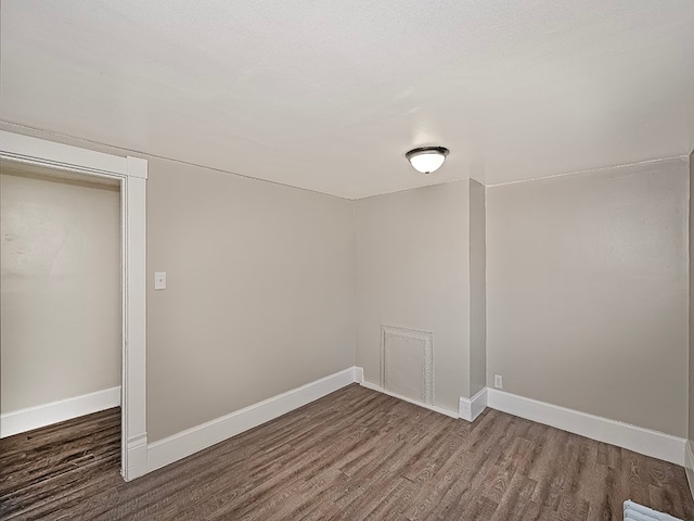 empty room with hardwood / wood-style floors