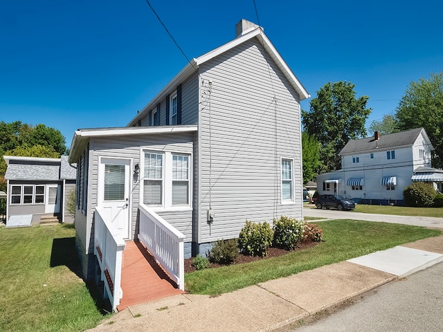 view of side of home featuring a yard