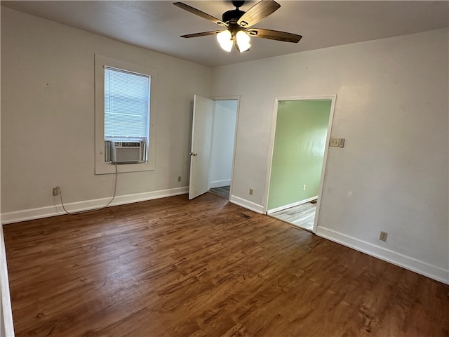 interior space featuring cooling unit, ceiling fan, and dark hardwood / wood-style flooring