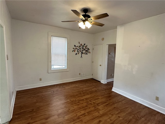 empty room with ceiling fan and dark hardwood / wood-style floors