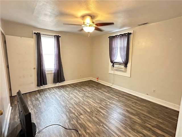 unfurnished room with ceiling fan, dark hardwood / wood-style flooring, and a textured ceiling