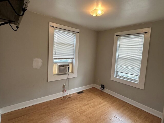 spare room featuring light hardwood / wood-style flooring and cooling unit