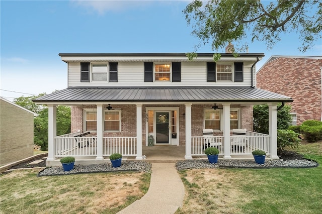 farmhouse inspired home featuring a front lawn and covered porch